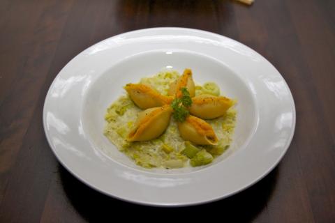 Bord conchiglie met pompoen en preisaus